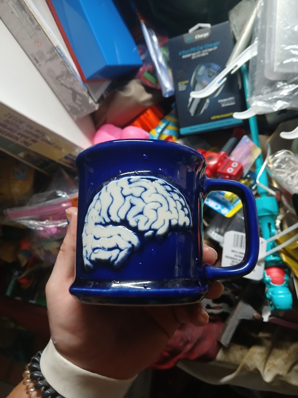 dark blue ceramic coffee mug featuring a raised, 3D embossed white human brain